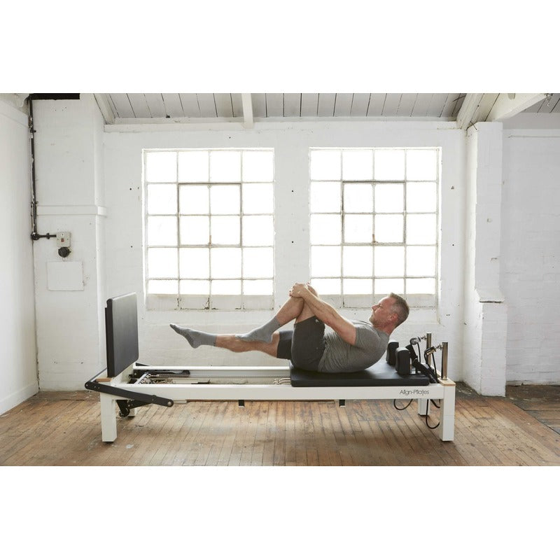 Align-Pilates C8-S Pro Pilates Reformer with man on reformer