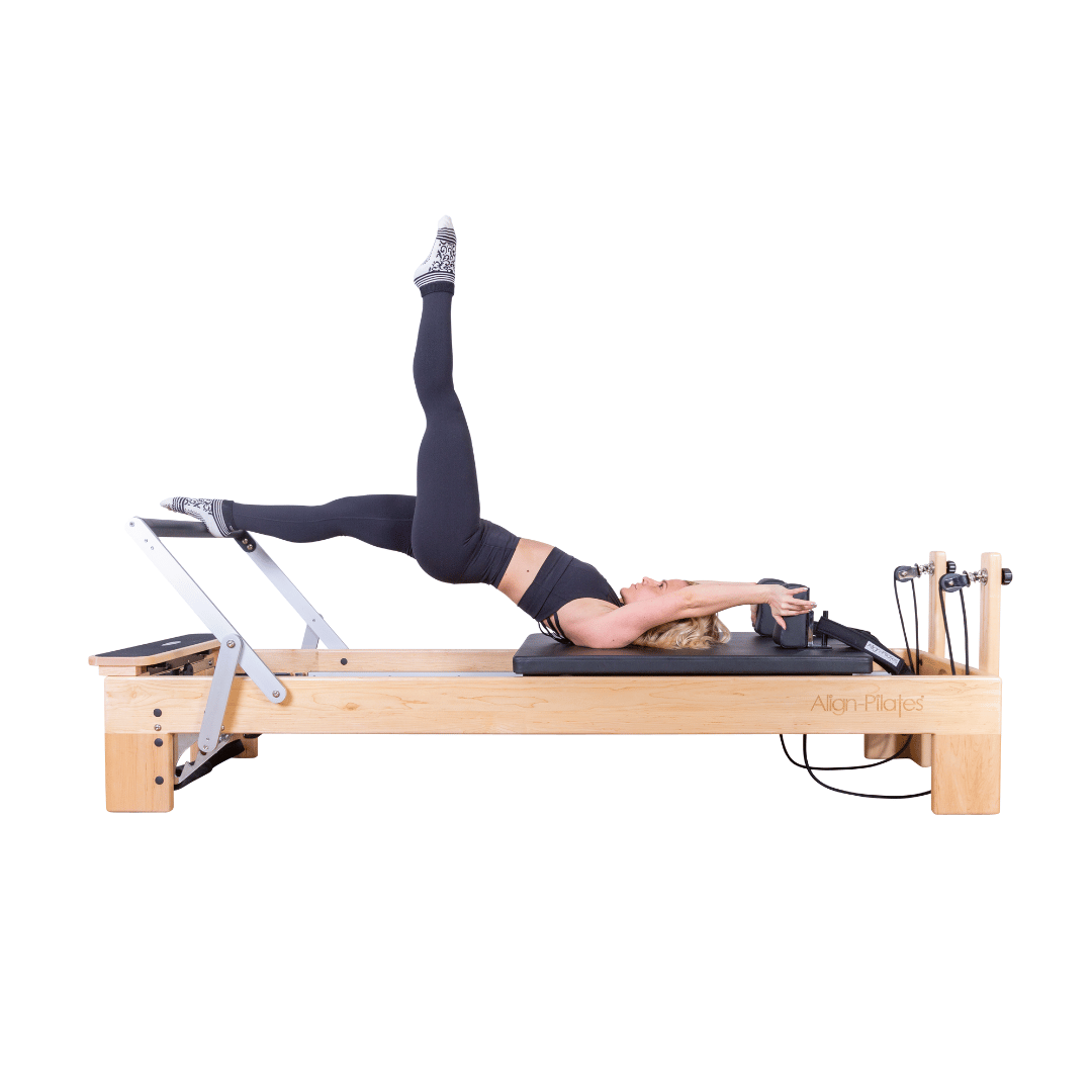 m-8 pro pilates reformer with woman doing pilates